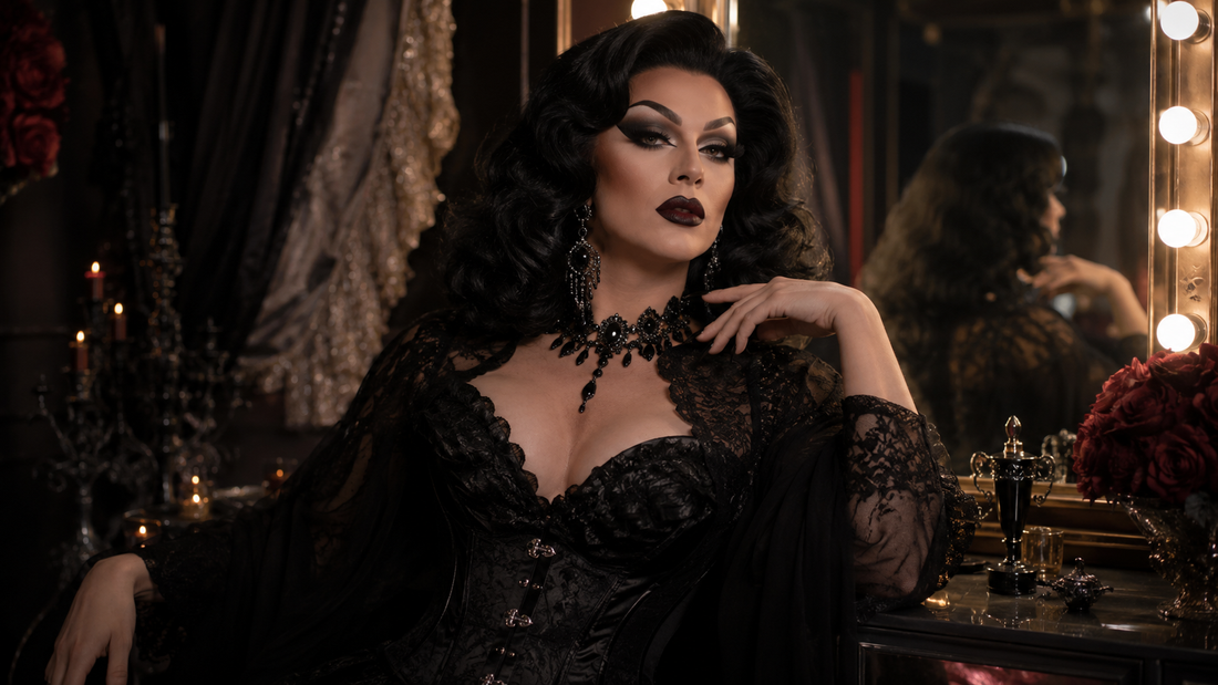 Drag queen in a dark glam look with dramatic makeup, voluminous wig, black sparkling outfit, statement jewelry and theatrical dressing-room lighting.