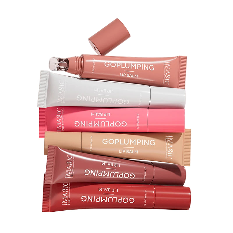 Collection of GoPlumping lip balm tubes in various shades on a light pink background