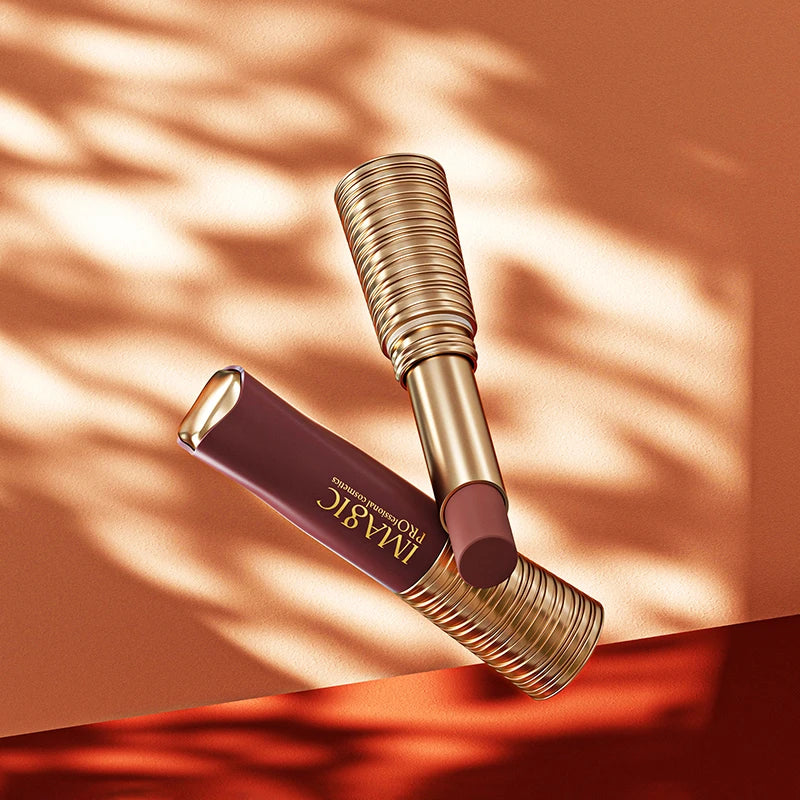 Lipstick with gold casing on a textured orange background