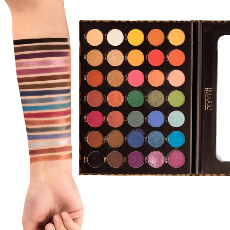 Makeup palette with colorful shades and a hand swatching colors on a striped sleeve.