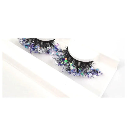 Decorative false eyelashes with sequins on a white background