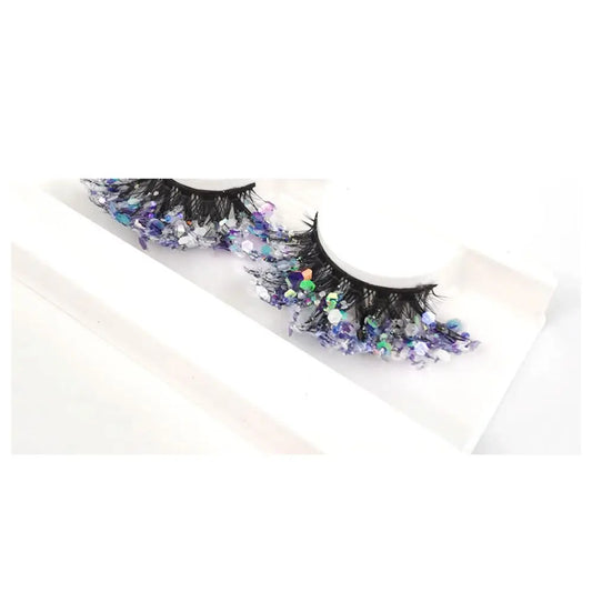Decorative false eyelashes with sequins on a white background